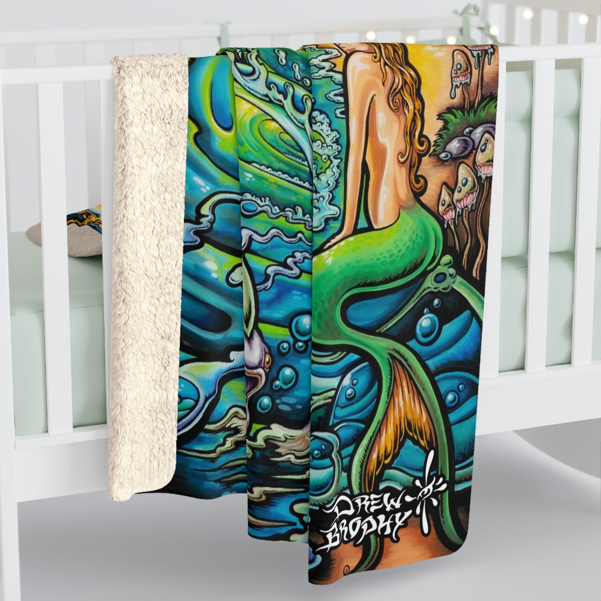 Colorful mermaid-themed towel with artistic design and brand name on a white background