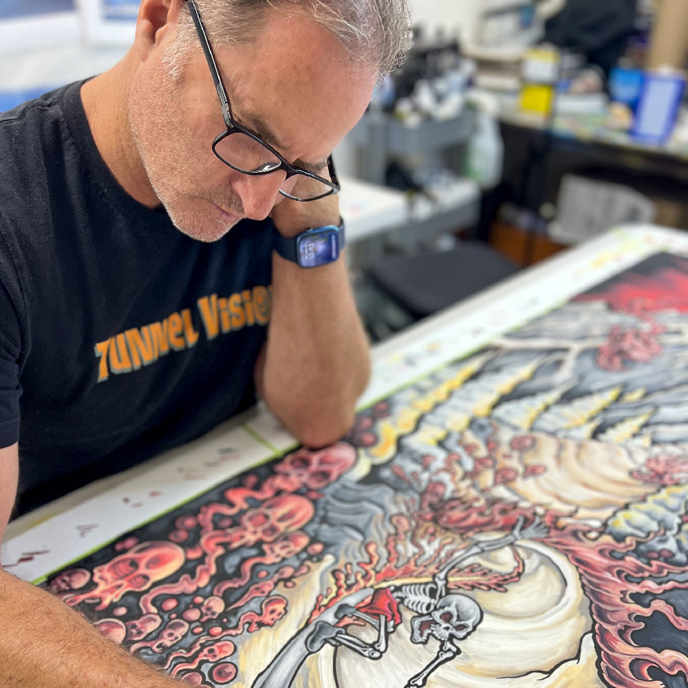 Drew Brophy working on a detailed artwork in a workshop setting